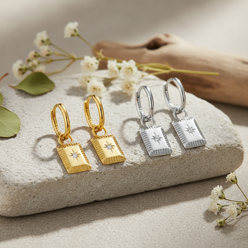 Gold and silver star charm hoops together with nature background