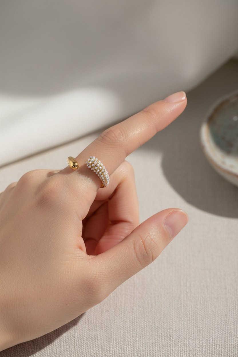 Model wearing open pearl band ring