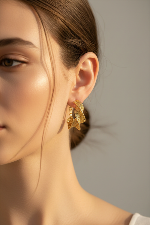 Textured gold twisted hoops on model