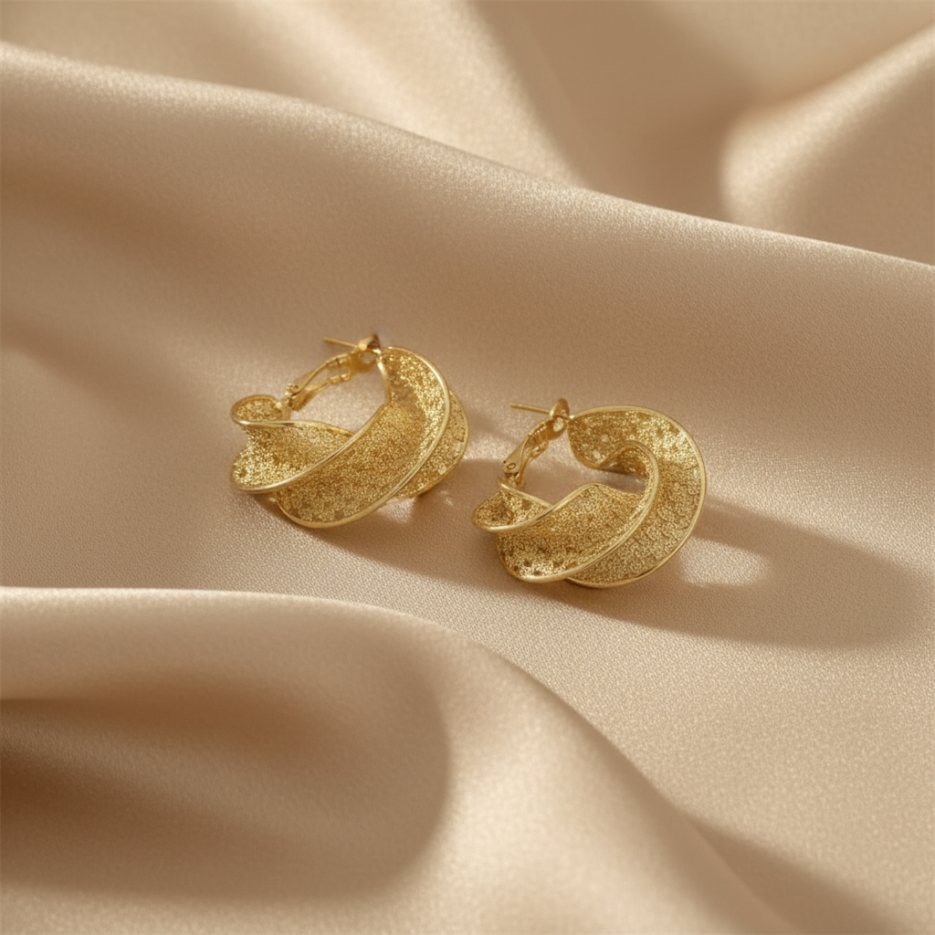 Textured gold twisted hoops on silk fabric
